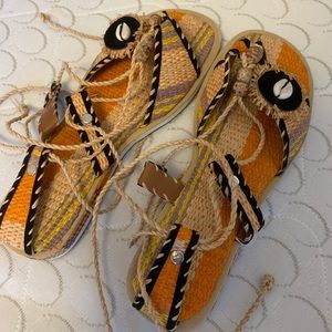 Flat sandals with straw material added to it